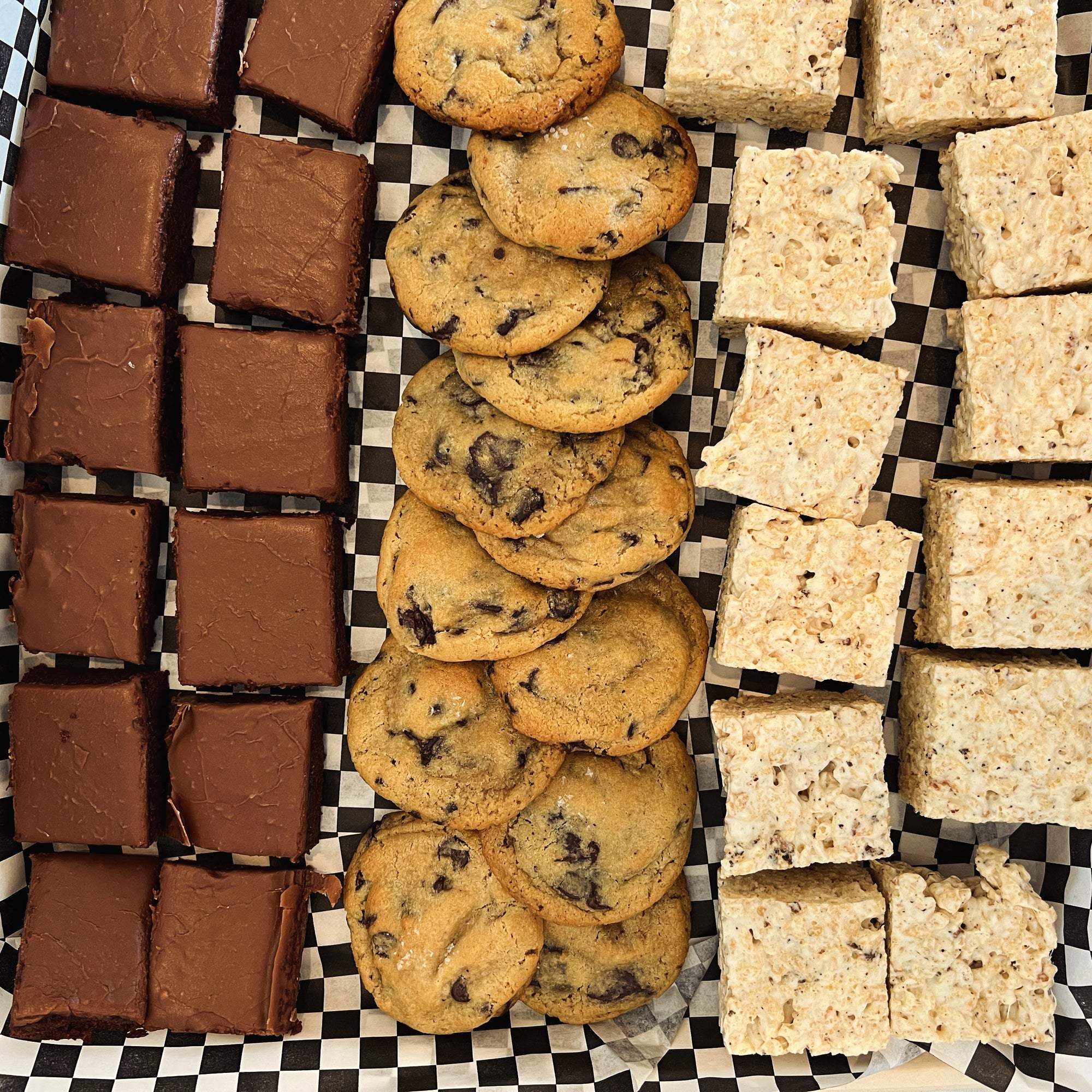 Tray of texas sheet cake, mini chocolate chip cookies, and mini rice cereal treats