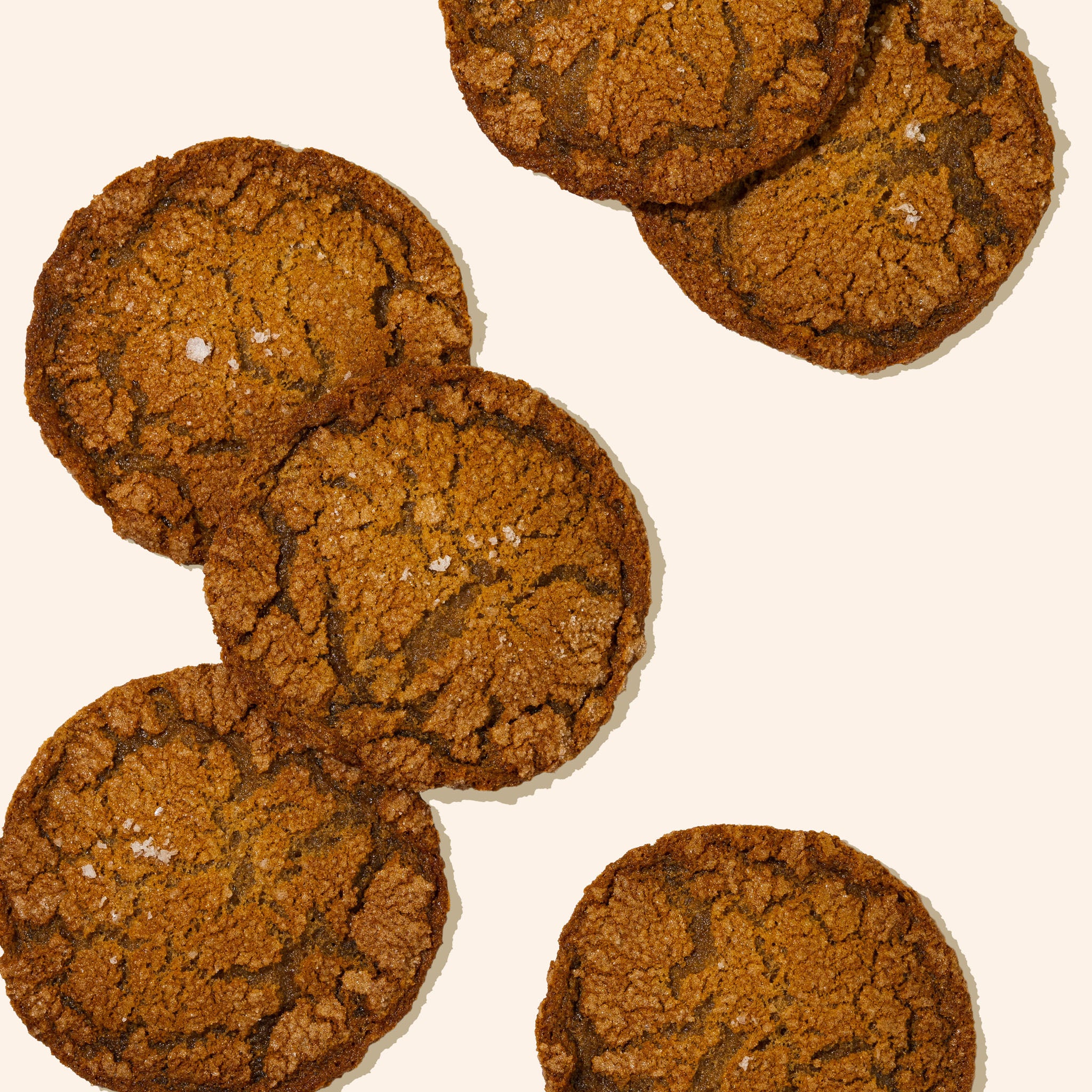 Piles of ginger molasses cookies on white background