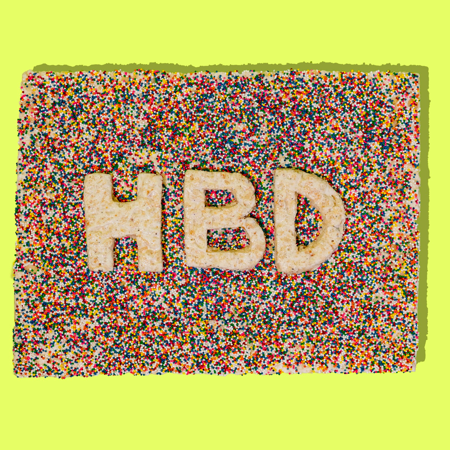 sprinkle rice cereal treat cake with HBD lettering