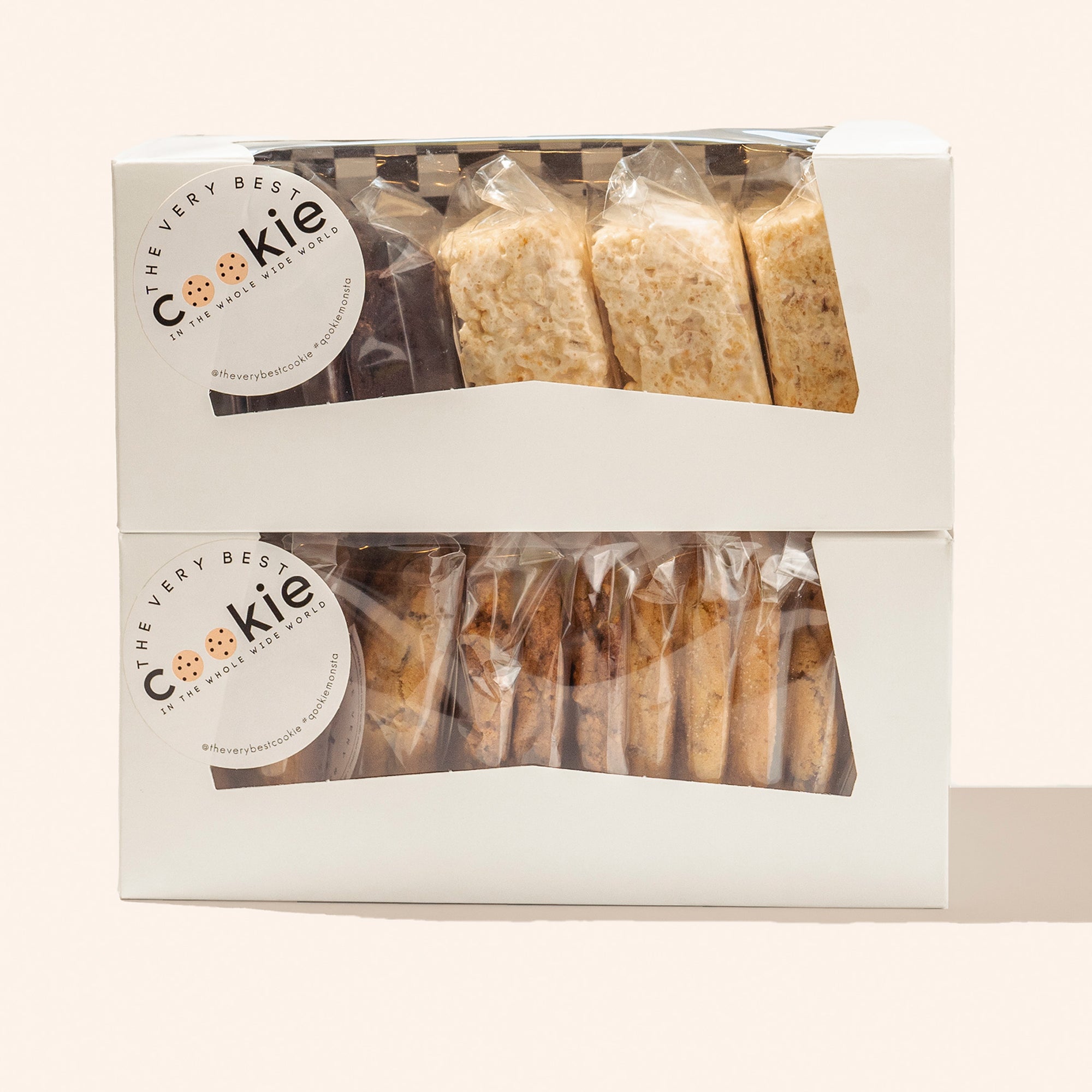 2 stacked boxes of wrapped and stickered cookies