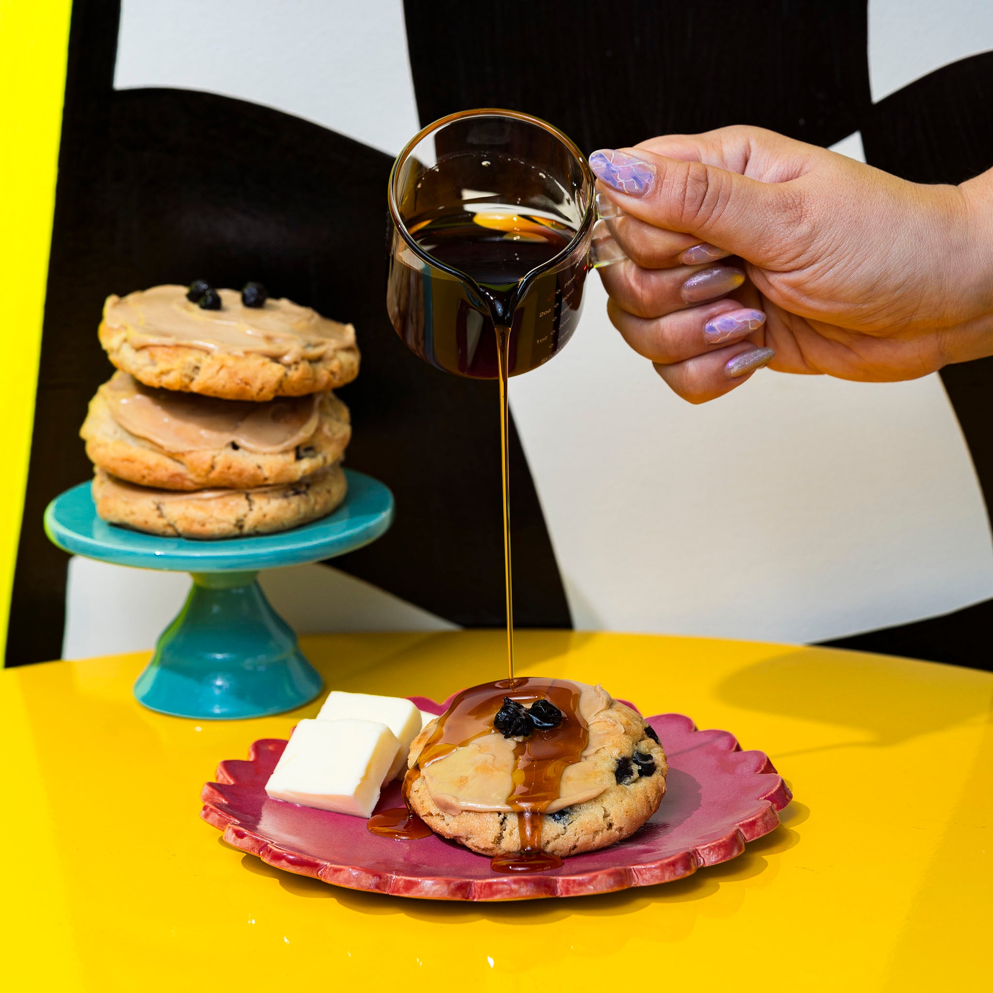 blueberry pancake cookie with maply syrup pouring on it