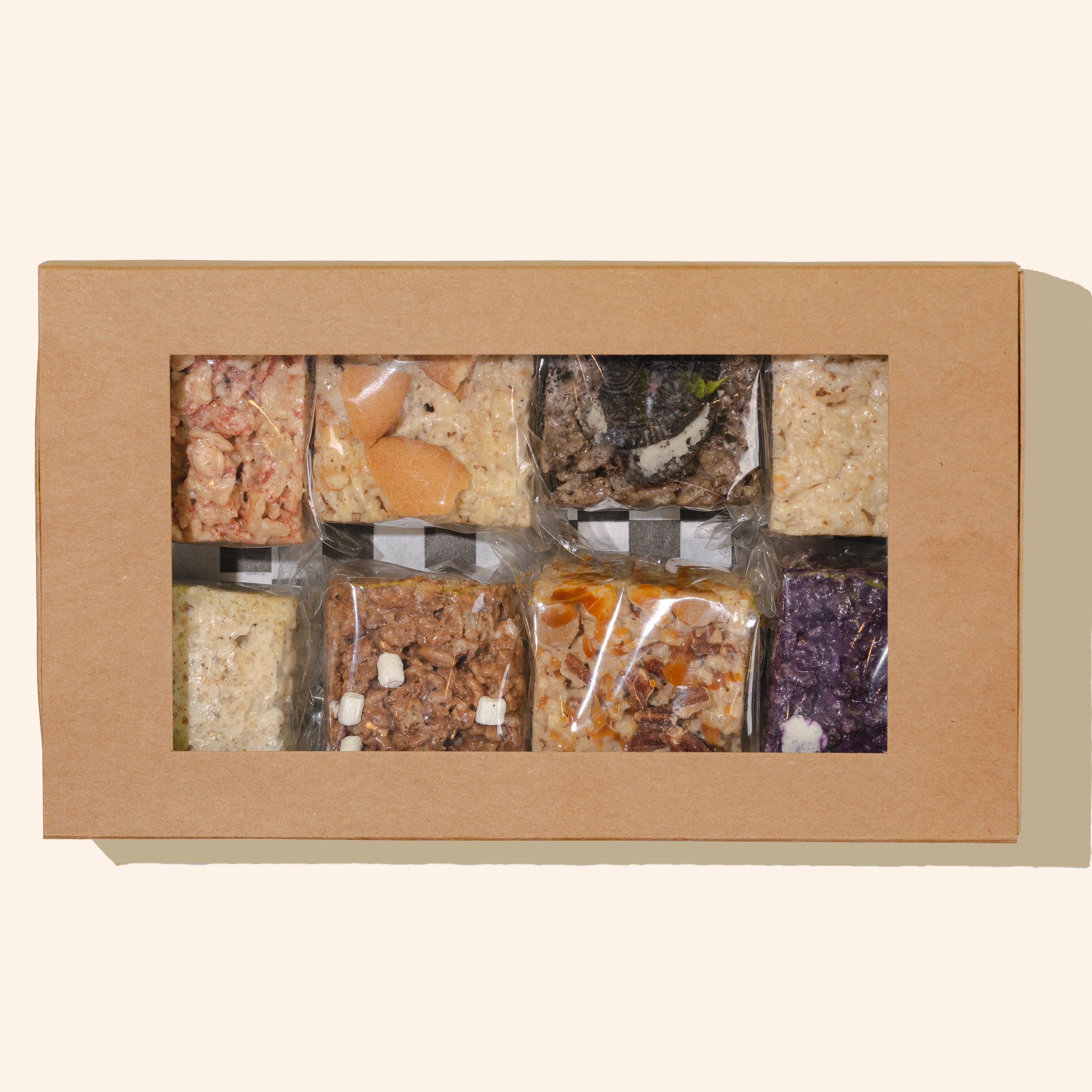 brown box filled with 8 individually wrapped rice cereal treats in many flavors