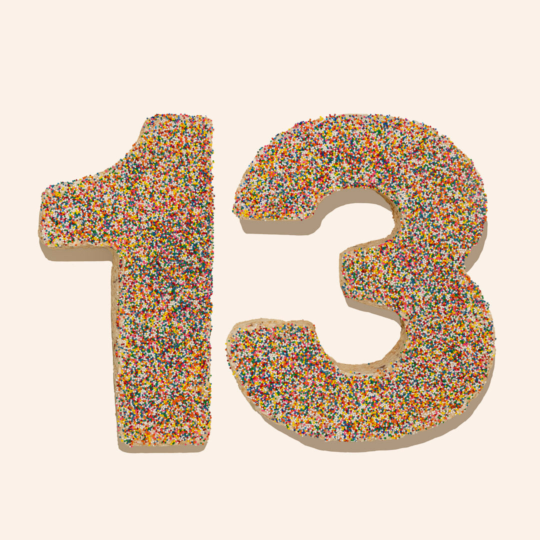 rice cereal treat cake molded into a "13" and topped with rainbow sprinkles