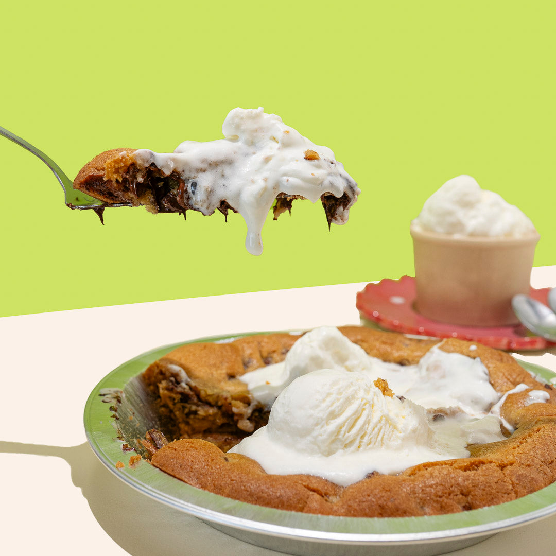 chocolate chip cookie cake a la mode with a slice being removed