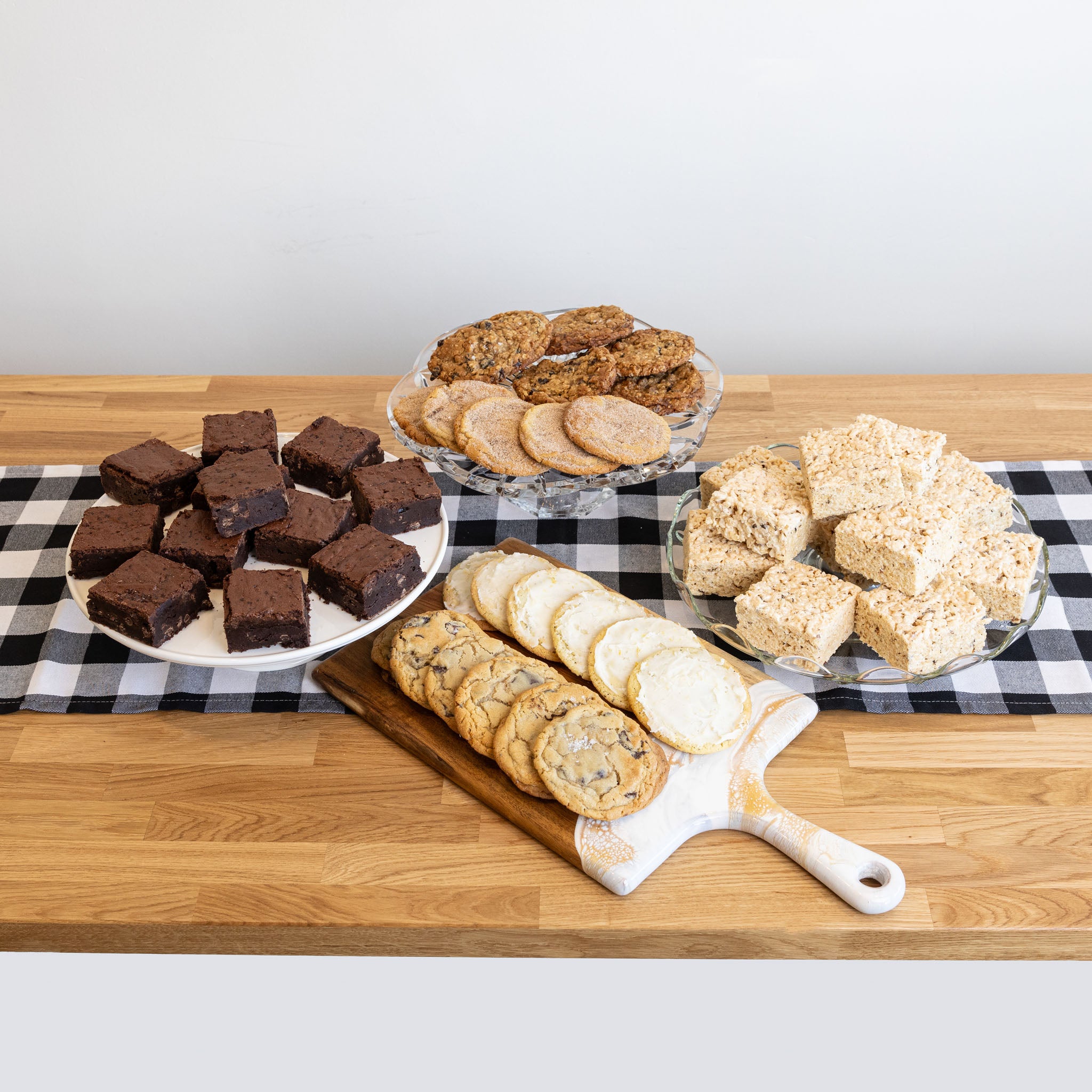trays of cookies, brownies, and RKTs on a table with a checkered runner