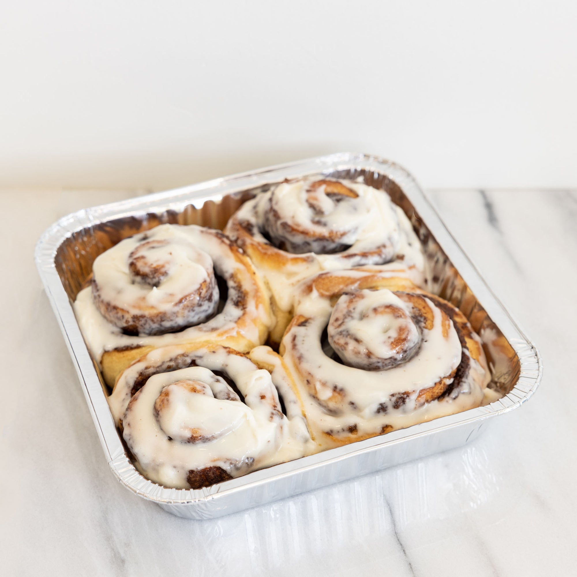 frosted tray of 4 cinnamon rolls