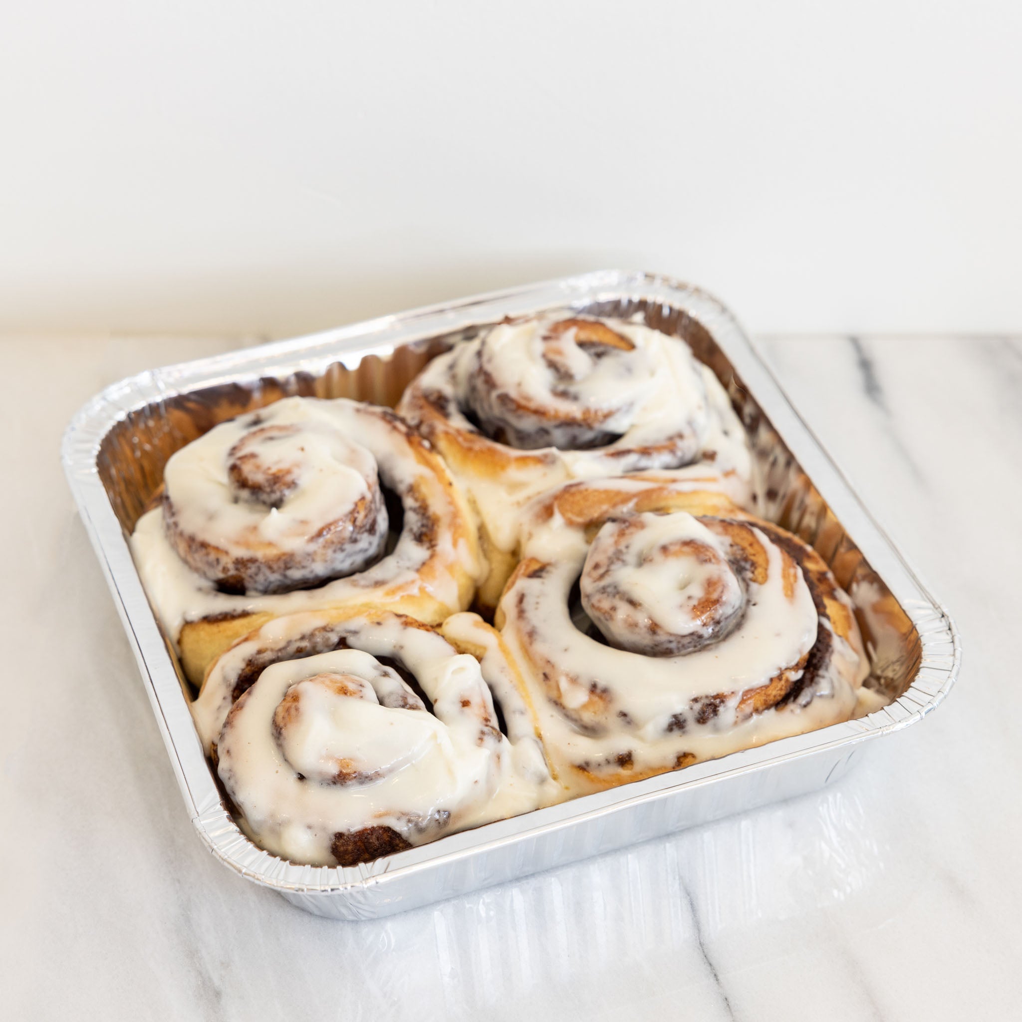 frosted tray of 4 cinnamon rolls